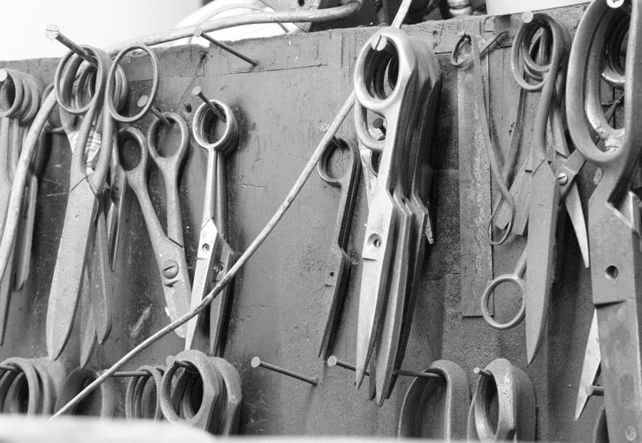Finished scissors and shears hanging on the workshop board