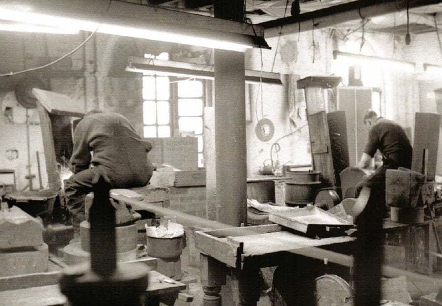 Two men working the grind stones