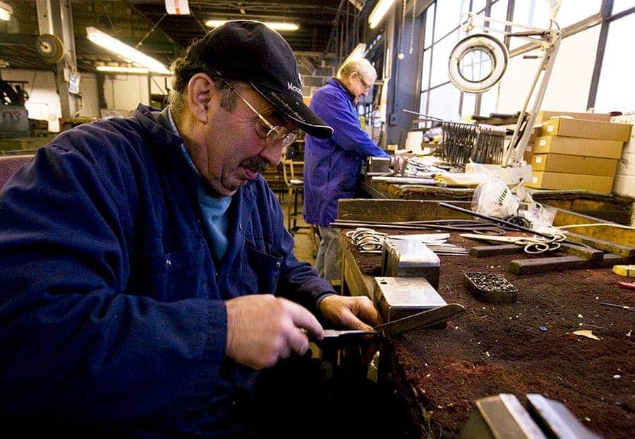An Ernest Wright putter-togetherer setting a pair of scissors by hand